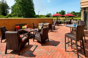 a patio with tables and chairs on a brick patio at Fairfield Inn & Suites by Marriott Syracuse Carrier Circle in East Syracuse