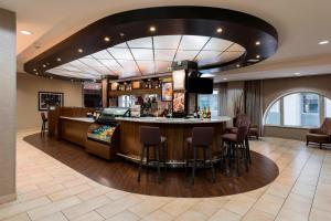 a bar in a hotel lobby with a bar counter at Courtyard by Marriott Tulsa Downtown in Tulsa