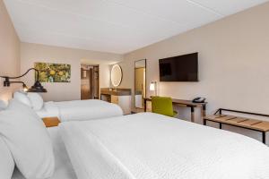 a hotel room with two beds and a flat screen tv at Fairfield Inn & Suites by Marriott Providence Airport Warwick in Warwick