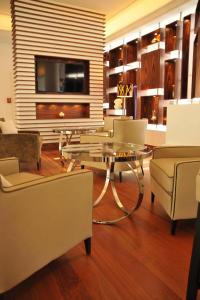 a living room with a glass table and chairs at AC Hotel by Marriott Ambassadeur Antibes - Juan Les Pins in Juan-les-Pins