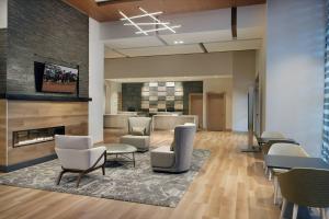 an office lobby with chairs and a fireplace at Residence Inn by Marriott Lexington City Center in Lexington