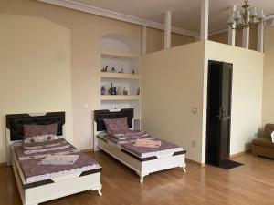 a room with two beds and a couch at Beaming_House in Sheki