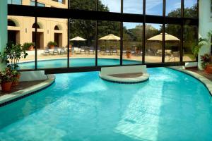 a large pool with blue water in a building at Austin Southpark Hotel in Austin