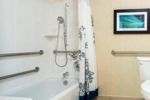 a bathroom with a shower and a tub and a toilet at Residence Inn Louisville Northeast in Louisville