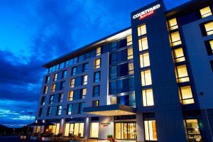 an office building with lights on at night at Courtyard by Marriott Aberdeen Airport in Dyce