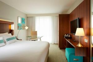 a hotel room with a bed and a television at Courtyard by Marriott Aberdeen Airport in Dyce