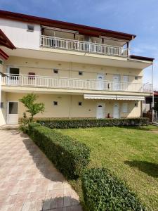 a large building with a large yard in front of it at ANNA ROOMS (Villa Anna) in Nea Vrasna