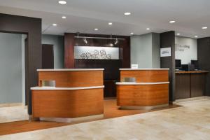 a lobby with two wooden counters at Courtyard Chicago Bloomingdale in Bloomingdale