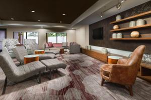 a large living room with couches and chairs at Courtyard Chicago Bloomingdale in Bloomingdale