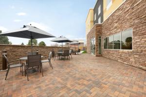 a patio with tables and chairs and umbrellas at Fairfield Inn & Suites by Marriott Boulder Longmont in Longmont