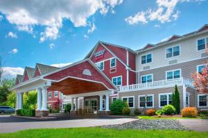 a hotel with a red and white building at Fairfield Inn & Suites by Marriott Great Barrington Lenox/Berkshires in Great Barrington