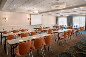 a conference room with tables and chairs and a screen at Fairfield Inn & Suites by Marriott Great Barrington Lenox/Berkshires in Great Barrington