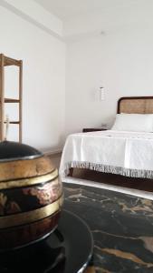 a bedroom with a bed and a table with a bowl at Mariluna in Modugno