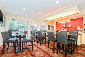 a bar with chairs and tables in a room at TownePlace Suites Houston Brookhollow in Houston