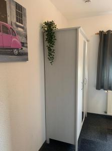 a white door with a plant on the wall at Hotel Zur Schleuse (Garni) in Datteln