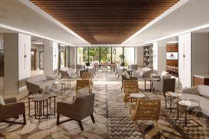 a lobby with couches and chairs and tables at Palm Beach Gardens Marriott in Palm Beach Gardens