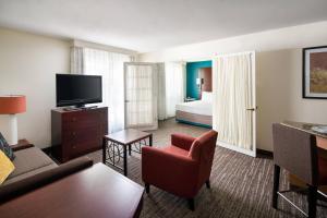 a living room with a room with a bed and a television at Residence Inn Pleasant Hill Concord in Pleasant Hill