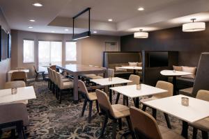 a dining room with tables and chairs and windows at Residence Inn Pleasant Hill Concord in Pleasant Hill