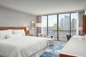 a hotel room with a bed and a large window at The Westin Bayshore, Vancouver in Vancouver