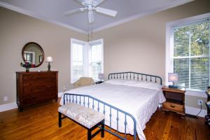 a bedroom with a bed and a ceiling fan at Marsh Mellow in Edisto Island