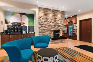 a lobby with blue chairs and a coffee shop at Fairfield Inn & Suites Mankato in Mankato