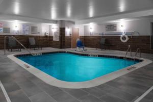 a large swimming pool in a building at Fairfield Inn & Suites Rocky Mount in Rocky Mount