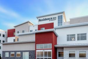 a red and white building with a sign on it at Residence Inn by Marriott St. Cloud in Waite Park