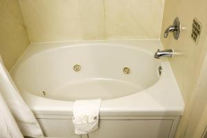 a white bath tub sitting in a bathroom at Fairfield Inn & Suites Oakland Hayward in Hayward
