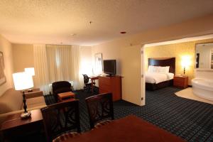 a hotel room with a bed and a bathroom at Fairfield Inn & Suites Oakland Hayward in Hayward