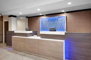 an office lobby with a blue painting on the wall at Fairfield Inn and Suites Wilson in Wilson