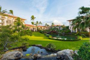 an exterior view of a resort with a pond at Marriott's Waiohai Beach Club in Koloa