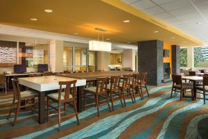 a large dining room with tables and chairs at Fairfield Inn & Suites by Marriott Calgary Downtown in Calgary