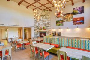 a restaurant with tables and chairs and a fireplace at SpringHill Suites Prescott in Prescott