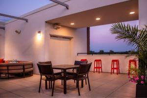 a patio with a table and chairs and a bar at SpringHill Suites By Marriott Frederick in Frederick