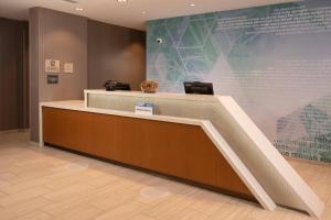 a lobby with a reception desk and a large screen at SpringHill Suites By Marriott Frederick in Frederick +25 photos