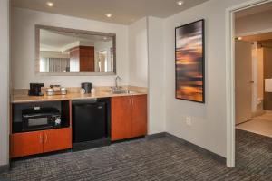 a kitchen with a sink and a microwave at Courtyard Dunn Loring Fairfax in Merrifield