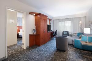 a hotel room with a bedroom and a living room at Courtyard by Marriott Pittsburgh Washington Meadow Lands in Washington