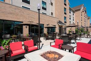a patio with tables and chairs and a fire pit at TownePlace Suites Joliet South in Joliet