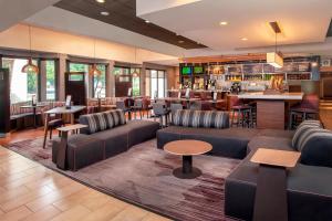 a hotel lobby with couches and a bar at Courtyard by Marriott Rockville in Rockville