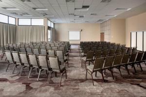 an empty room with rows of chairs and a screen at Courtyard by Marriott Rockville in Rockville