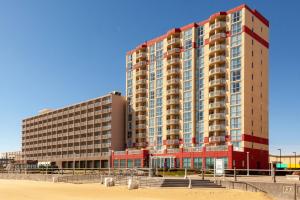 a large building on the beach next to a beach at Residence Inn By Marriott Virginia Beach Oceanfront in Virginia Beach