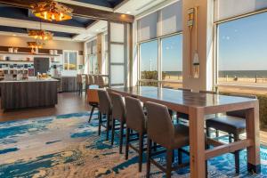 a dining room with a table and chairs with a view of the beach at Residence Inn By Marriott Virginia Beach Oceanfront in Virginia Beach