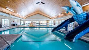 a swimming pool with a water slide in a building at TownePlace Suites Rochester in Rochester