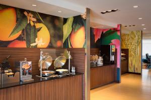 a restaurant with a counter and a bar at Fairfield Inn & Suites by Marriott Dallas West/I-30 in Dallas