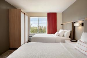 a hotel room with two beds and a window at SpringHill Suites Phoenix Chandler/Fashion Center in Chandler