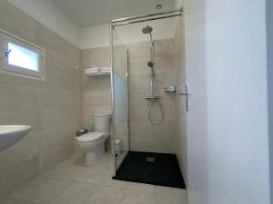 a bathroom with a shower with a toilet and a sink at Hotel & Appartements Punta e Mare in Cargèse