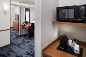 a hotel room with a microwave and a room at Fairfield Inn & Suites South Bend at Notre Dame in South Bend