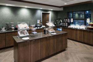 a restaurant with a counter with pastries on it at Fairfield Inn & Suites South Bend at Notre Dame in South Bend