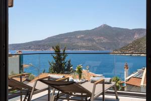 a balcony with chairs and a view of the water at Gorgeous 3 Bedroom Property at Kalamar Bay in Kalkan
