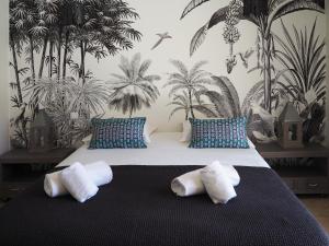 a bedroom with a bed with two pillows on it at Songes d’été in Bonifacio
